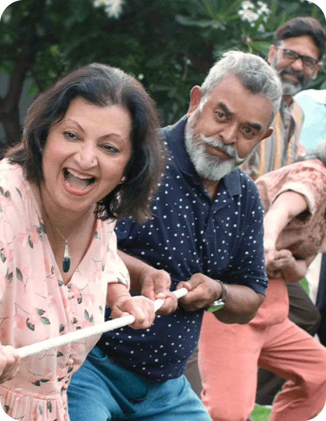 Friends laughing during a game of tug of war