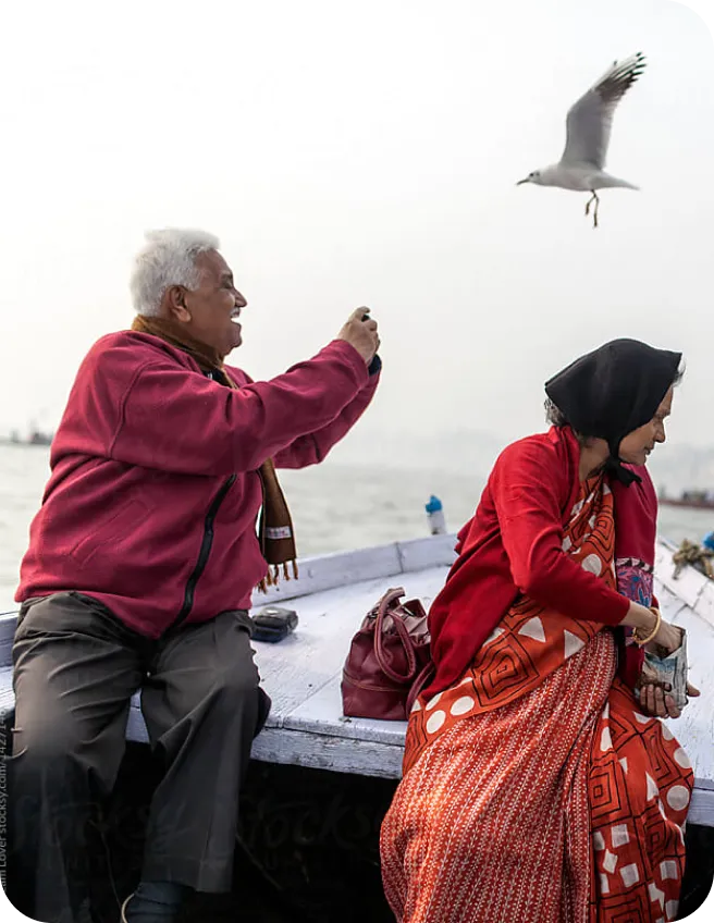 A couple on a boat photographing a seagull